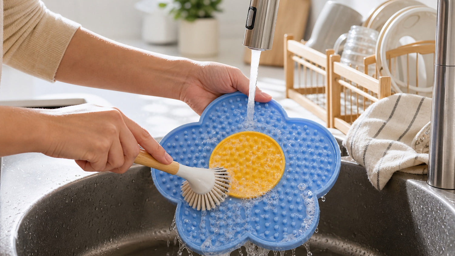 LickBloom silicone lick mat being cleaned in a kitchen sink